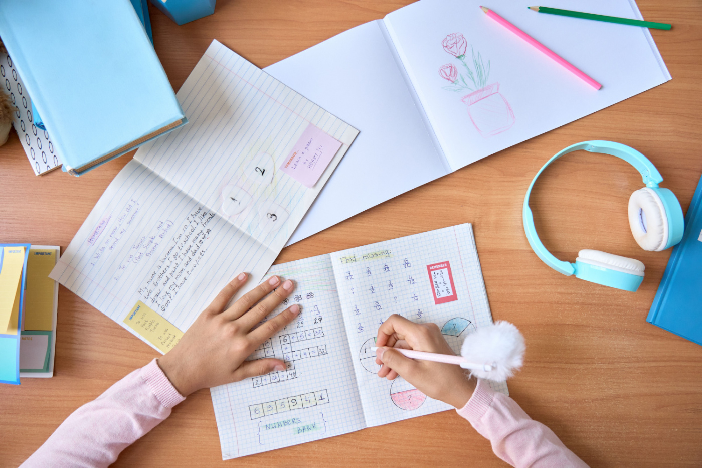Young girl drawing in notebook