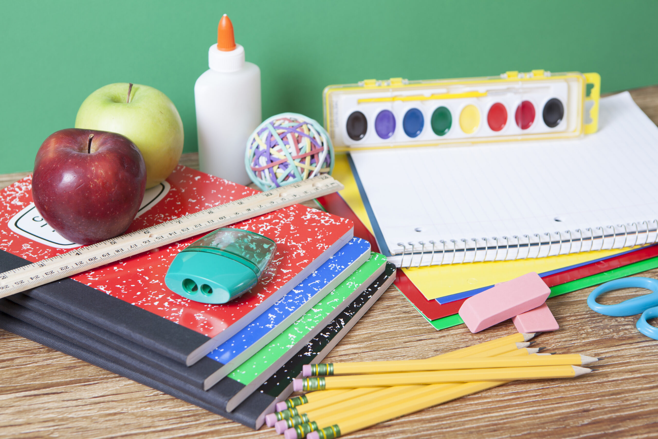 School supplies including pencils, notebooks, rulers, and paint